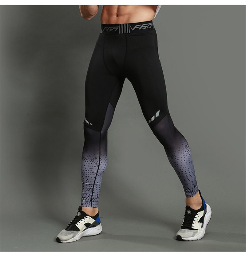 Model wearing black and grey gradient men's sports leggings, designed for compression and performance during workouts or running.